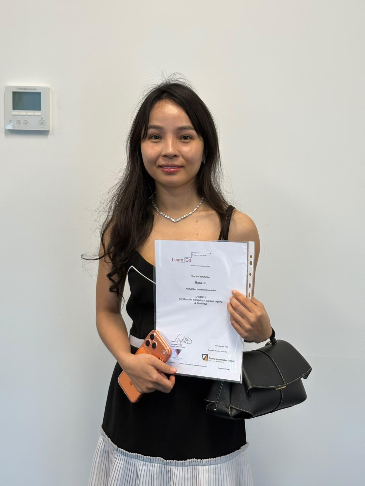 Hara Ho holding their LearnEd Training certificate